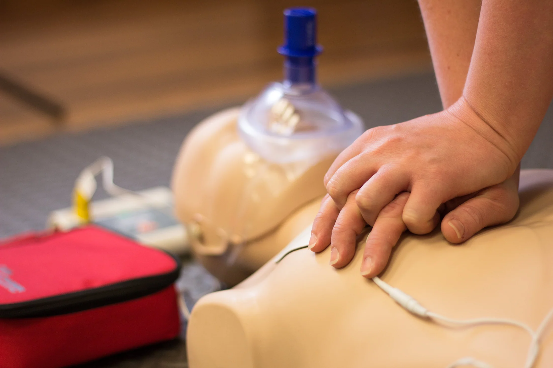 CPR training in progress person performing CPR on dummy